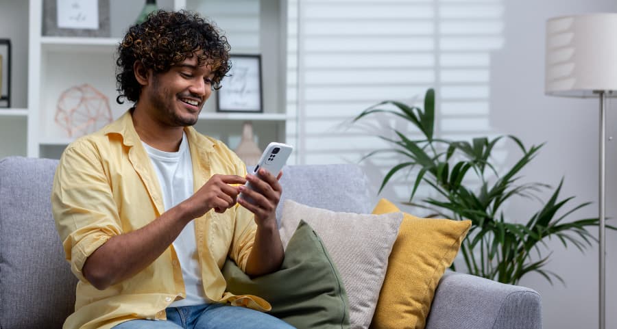 Homeowner using a home security app on his mobile device